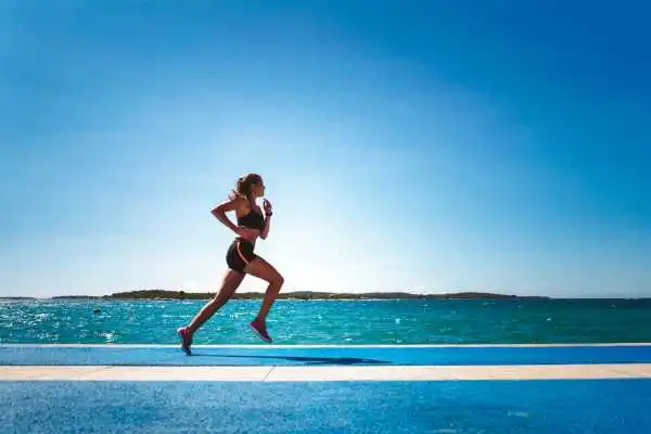 Woman running showing strong leg muscle Dunstable